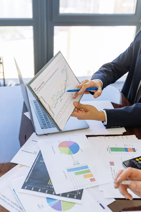 Investment professionals analysing reports and market data